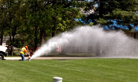 man flushing hydrant
